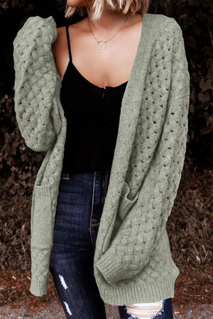 Sage open-knit pocket cardigan with textured sleeves and a relaxed fit.