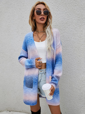 Rainbow gradient knit cardigan with pockets, open front, long sleeves, and a relaxed fit.