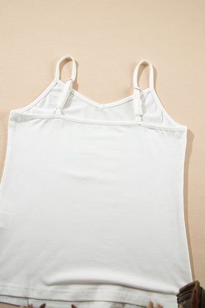 White cami with adjustable straps and V-neck detail.