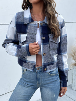 Checked plaid shacket in blue and white with patch pockets and button closure.