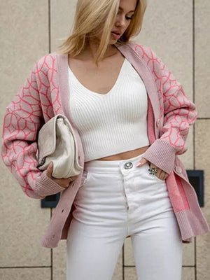 Dusty pink geometric knit button-up cardigan with pink pattern and ribbed cuffs.