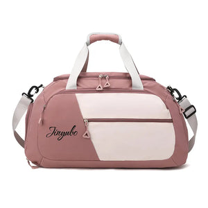 Colorblock travel duffel bag in dusty pink and cream with logo detail and adjustable strap.