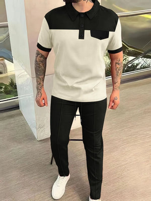 Colorblock polo shirt with black collar and pocket, paired with black track pants.