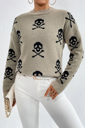 Cosmic motif mock neck knit sweater in khaki with black skull and crossbones pattern.