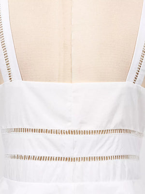White midi dress with eyelet embroidery detail on straps and horizontal cutouts.