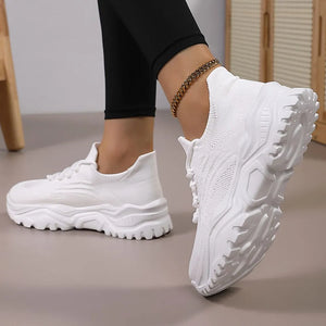 White textured knit sneakers with a chunky sole and laces.