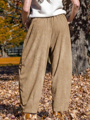 Wide-leg corduroy pants in brown with pockets and an elastic waistband.