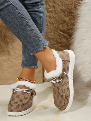 Taupe Southwestern print faux fur lined loafers with white laces and white soles.