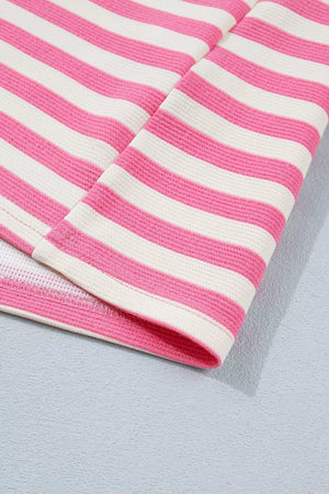 Polyester tee with pink and white horizontal stripes, short sleeves, and a textured knit.