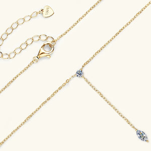 Gold lariat necklace with marquise moissanite pendant and adjustable clasp.