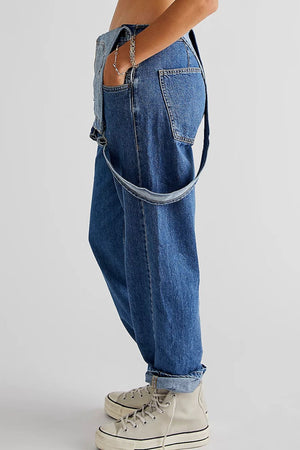 Relaxed fit denim overalls in medium wash cotton with crisscross straps and cuffed hems.