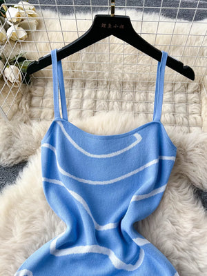 Blue wavy knit midi dress with spaghetti straps and white stripes.
