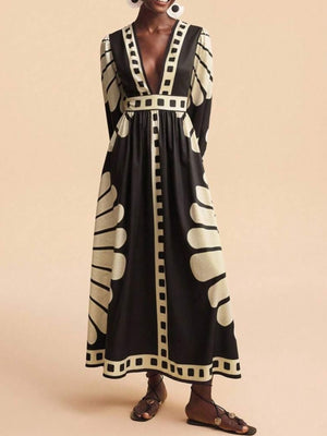 Black and cream geometric print maxi dress with deep V-neck and long sleeves.
