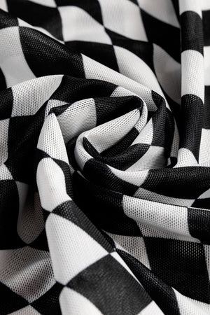 Black and white checkered mesh blouse with an optical illusion pattern.