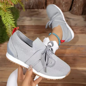 Gray knit & suede lace-up sneakers with red heel tab detail.