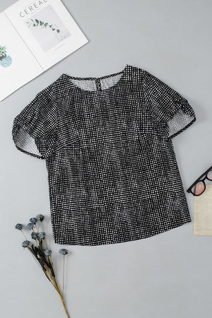Black dotted puff sleeve blouse with a round neckline.