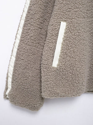 Dust Storm teddy fleece zip-up jacket with white contrast piping and pocket detail.