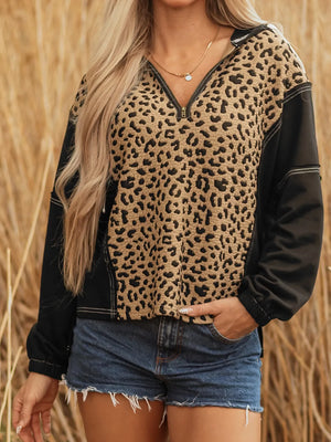 Leopard print zip hoodie with black sleeves and contrast stitching.