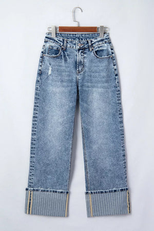 Cuffed mid-rise relaxed fit jeans in light wash denim with distressed details and striped cuffs.