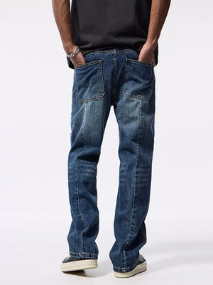 Relaxed fit blue denim jeans with patchwork details and distressed wash.