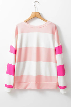 Striped sweatshirt in blush pink and white with hot pink block sleeves and crewneck.