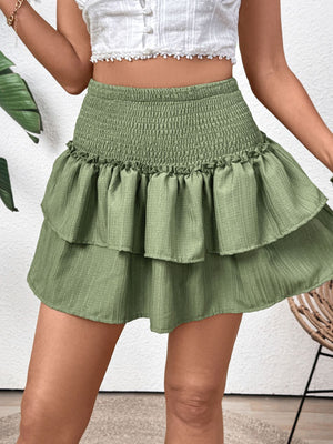 Tiered ruffle mini skirt in matcha green with a smocked waist and textured fabric.