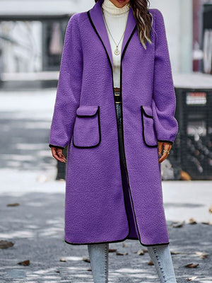 Purple teddy coat with contrast trim detailing and patch pockets.