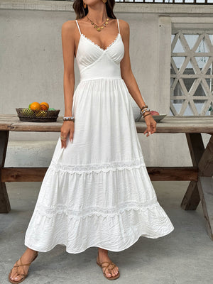 White lace tiered maxi dress with scalloped neckline and spaghetti straps.
