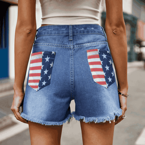 Distressed denim shorts with American flag pocket details and frayed hem
