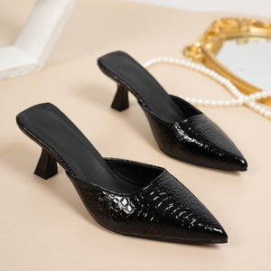 Black croc-embossed pointed toe flare heel mules with a slip-on design.