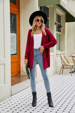 Wine cable-knit long sleeve cardigan with pockets and a relaxed fit.