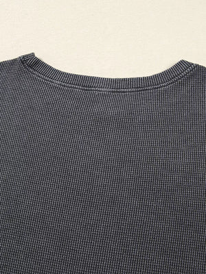 Dark gray waffle knit oversized sweatshirt with crew neck detail.