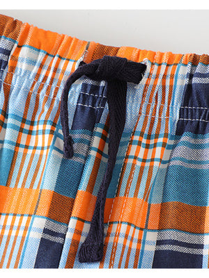 Toddler plaid shorts with elastic waist and drawstring in blue, orange, and white cotton.