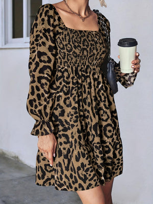 Leopard print mini dress with smocked bodice, square neck, and ruffled cuffs in olive brown.