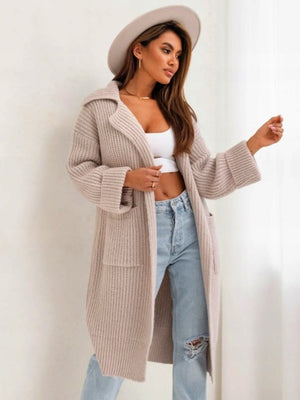 Oversized knit lapel cardigan in cream with cuffed sleeves and front pockets.