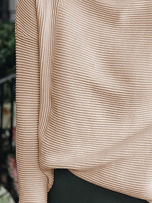 Relaxed ribbed turtleneck knit sweater in sand, featuring a textured ribbed pattern and long sleeves.