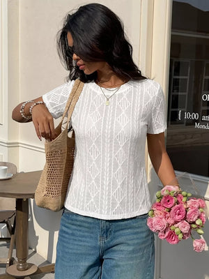 White textured knit maternity t-shirt with crew neck and short sleeves, featuring a diamond pattern and subtle bow detail.