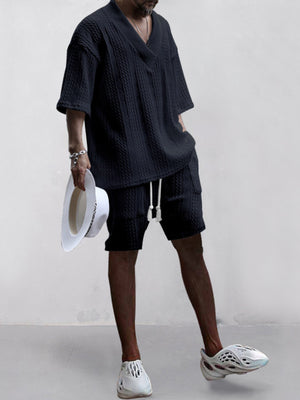 Black cable-knit V-neck two-piece set with shorts and short sleeves.