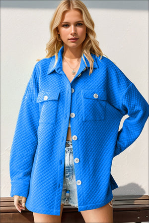 Diamond quilted oversized shirt jacket in blue with button front and chest pockets.