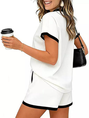 White polo collar two-piece set with black trim, drawstring shorts with pockets.