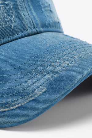 Distressed denim baseball cap with visible stitching details.