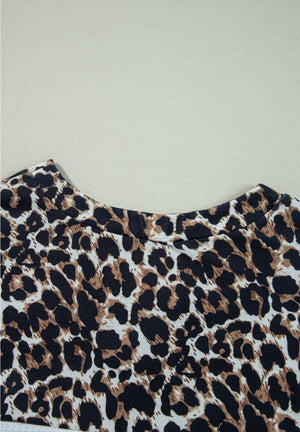 Leopard print waffle knit henley sweater with crew neck.