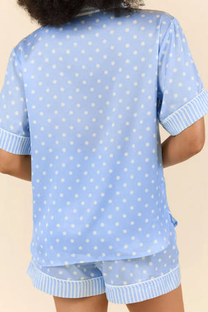 Blue polka dot viscose pajama set with striped trim shorts and short sleeve button-down top.