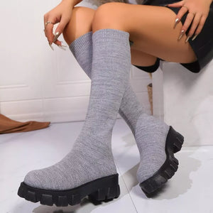 Gray knit knee-high boots with chunky platform soles.