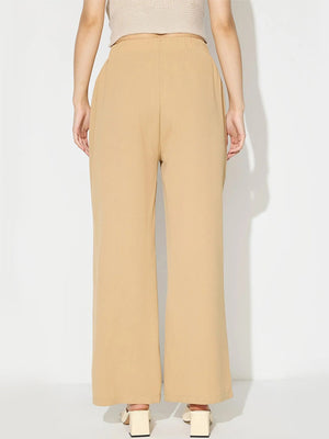 Tan wide leg trousers with a tailored seam front and buttoned detail.