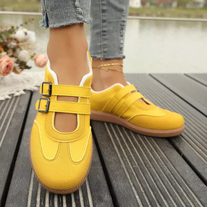 Yellow Mary-jane inspired sneakers with double buckle straps and contrast stitching.