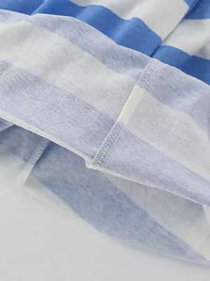 Blue and white striped cotton t-shirt hem detail with visible stitching.