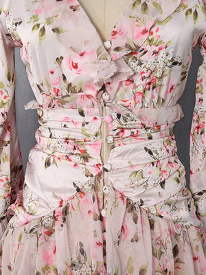 Charming ruffled floral mini dress with buttoned front and ruched waist detail.