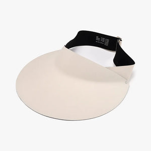 Sculptural visor sun shield in ivory with a wide brim and adjustable black band.