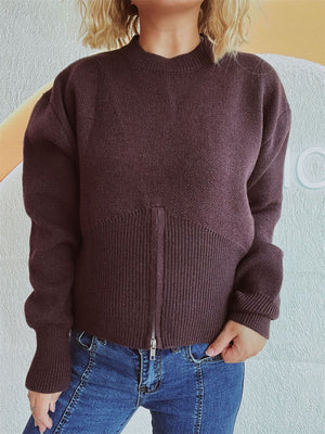 Chocolate zip-front knit sweater with ribbed hemline and mock neck.